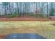 Deck overlooks a fenced backyard with wooded area at 1650 Willow Way, Woodstock, GA 30188