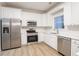 Modern kitchen with white cabinets and stainless steel appliances at 1650 Willow Way, Woodstock, GA 30188