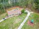 Ranch-style home with a large yard, long driveway, and playset at 1907 Old Loganville Rd, Loganville, GA 30052