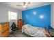 Small bedroom with blue accent wall, dresser, and twin bed at 1907 Old Loganville Rd, Loganville, GA 30052