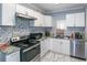 Efficient kitchen with white cabinets, granite countertops, and tiled backsplash at 1907 Old Loganville Rd, Loganville, GA 30052