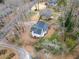 Aerial view of home surrounded by trees with driveway and patio at 517 Stonehedge Dr, Stone Mountain, GA 30087