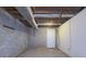 Unfinished basement with concrete floor and white walls at 517 Stonehedge Dr, Stone Mountain, GA 30087