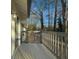 Gray deck with wooden railing overlooking wooded area at 517 Stonehedge Dr, Stone Mountain, GA 30087