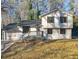 Two-story house with stone and white siding, gray deck, and attached garage at 517 Stonehedge Dr, Stone Mountain, GA 30087