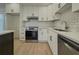 Modern kitchen featuring white cabinets, stainless steel appliances, and stylish backsplash at 517 Stonehedge Dr, Stone Mountain, GA 30087