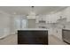 Modern kitchen with white cabinets, quartz countertops and stainless steel appliances at 517 Stonehedge Dr, Stone Mountain, GA 30087