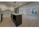 Open-concept kitchen flowing into the living area, featuring a large island and modern appliances at 517 Stonehedge Dr, Stone Mountain, GA 30087