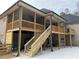 Two tiered deck with screen porch overlooks the backyard at 5710 Breitling Dr, Cumming, GA 30028