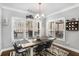 Bright dining room with farmhouse table and large windows at 5710 Breitling Dr, Cumming, GA 30028