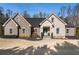 Brick house with landscaping and a light teal front door at 5710 Breitling Dr, Cumming, GA 30028