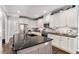 Modern kitchen with white cabinets, black countertops, and stainless steel appliances at 5710 Breitling Dr, Cumming, GA 30028