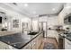 Spacious kitchen with white cabinets, large island, and dark countertops at 5710 Breitling Dr, Cumming, GA 30028