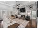 Comfortable living room with fireplace, built-in shelving, and large windows at 5710 Breitling Dr, Cumming, GA 30028