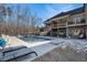 Luxury pool with spacious deck and multiple lounge chairs at 5710 Breitling Dr, Cumming, GA 30028