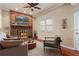 Cozy living room featuring a brick fireplace and hardwood floors at 647 Shannon Green Cir, Mableton, GA 30126