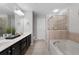 Bathroom with double sinks, soaking tub, and shower at 704 Woodland Pl, Woodstock, GA 30188