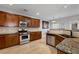 Spacious kitchen with granite countertops and stainless steel appliances at 704 Woodland Pl, Woodstock, GA 30188