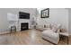 Light-filled living room featuring a sectional sofa and a modern fireplace at 704 Woodland, Woodstock, GA 30188