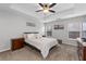 Main bedroom with ceiling fan and large bed at 704 Woodland Pl, Woodstock, GA 30188