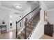 Elegant entryway with a modern staircase and neutral color palette at 704 Woodland, Woodstock, GA 30188