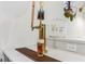 Close-up of a gold bar faucet with a beer tap and glasses at 370 Park Ne Pl, Atlanta, GA 30317