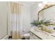 Stylish powder room with patterned wallpaper and granite vanity at 370 Park Ne Pl, Atlanta, GA 30317