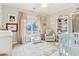 Charming bedroom with a crib, armchair, and large window at 370 Park Ne Pl, Atlanta, GA 30317