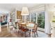 Bright dining area with white table and hardwood floors, overlooking backyard at 370 Park Ne Pl, Atlanta, GA 30317