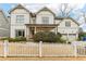 Two-story house with white siding, two-car garage, and white picket fence at 370 Park Ne Pl, Atlanta, GA 30317