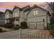 Two-story house with gray siding, two-car garage, and white picket fence at 370 Park Ne Pl, Atlanta, GA 30317