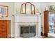 Elegant marble fireplace with brass screen, decorative mantel, and art at 370 Park Ne Pl, Atlanta, GA 30317