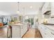 Modern kitchen with white cabinets, marble counters, and a large island at 370 Park Ne Pl, Atlanta, GA 30317