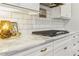 White kitchen with marble countertops and gas cooktop at 370 Park Ne Pl, Atlanta, GA 30317