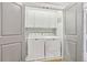 Bright laundry room with white cabinets and washer/dryer at 370 Park Ne Pl, Atlanta, GA 30317