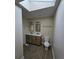 Double vanity bathroom with skylight and wood-look floors at 387 Lassetter Rd, Sharpsburg, GA 30277