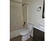 Clean bathroom with a tub, toilet, and vanity with a dark wood cabinet at 387 Lassetter Rd, Sharpsburg, GA 30277