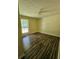 Spacious bedroom with wood-look flooring and large window at 387 Lassetter Rd, Sharpsburg, GA 30277