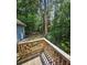 Deck view of backyard with lush trees and partial view of home at 387 Lassetter Rd, Sharpsburg, GA 30277