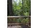 Deck overlooking a peaceful wooded area with a glimpse of water at 387 Lassetter Rd, Sharpsburg, GA 30277