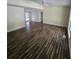 Large living room featuring dark brown wood-look flooring at 387 Lassetter Rd, Sharpsburg, GA 30277