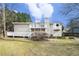 Back exterior view of house and deck overlooking a spacious grassy yard at 4196 Jami Ln, Snellville, GA 30039