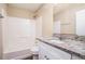 Bathroom with granite countertop vanity, framed mirror, and tiled shower at 4196 Jami Ln, Snellville, GA 30039