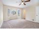 Comfortable main bedroom featuring neutral walls, ceiling fan, and a unique window at 4196 Jami Ln, Snellville, GA 30039