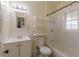 Simple bathroom with shower/tub combo, vanity, and window at 523 North Ave, Hapeville, GA 30354