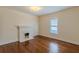 Hardwood floors and a fireplace accent this sunny bedroom at 523 North Ave, Hapeville, GA 30354