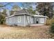 Home's backyard features a grey siding, a concrete patio, and a partial fence at 118 Strickland St, Fairburn, GA 30213