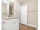 Bathroom featuring modern vanity with granite countertop and updated fixtures at 118 Strickland St, Fairburn, GA 30213