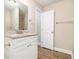 Bright bathroom features granite counters, white cabinets, and wood-look flooring at 118 Strickland St, Fairburn, GA 30213