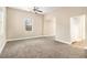 Spacious room featuring a ceiling fan and plush carpeting throughout at 118 Strickland St, Fairburn, GA 30213